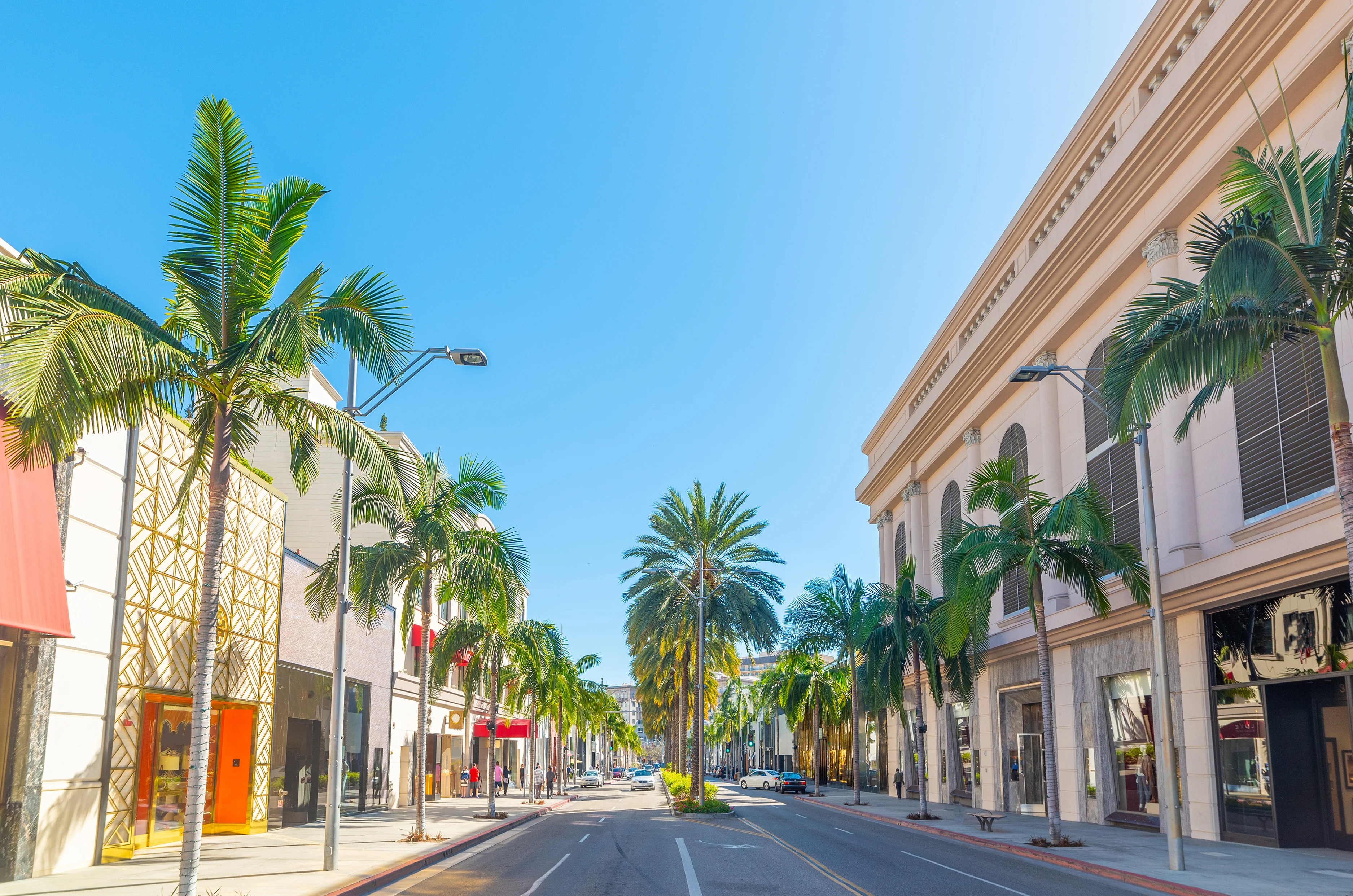Luxury stores and palm trees in world famous Rodeo Drive in Beverly Hills. Los Angeles, California, USA