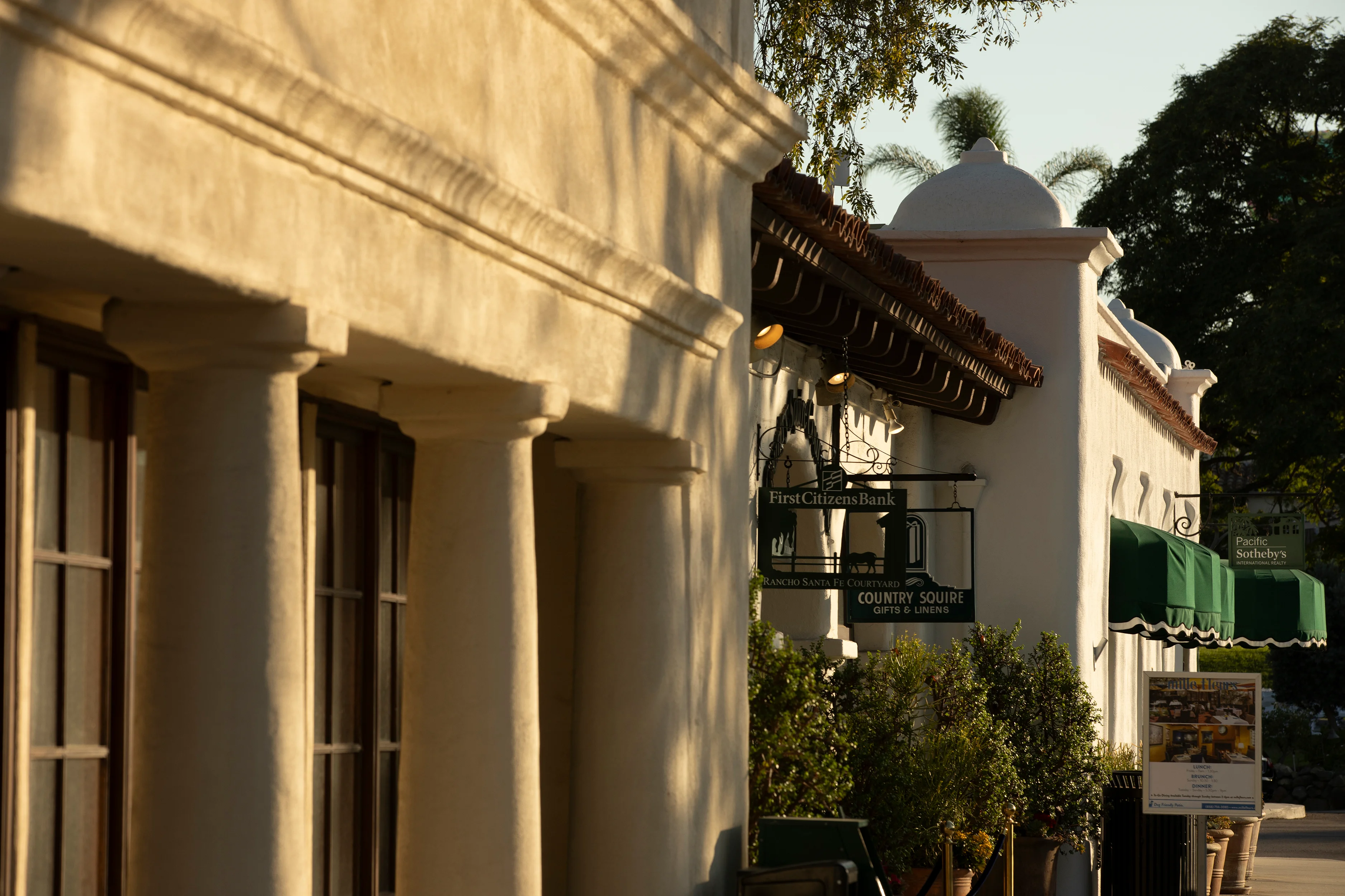Rancho Santa Fe, California, USA - September  3, 2022: Afternoon light shines on mission revival style buildings of historic downtown Rancho Santa Fe.
