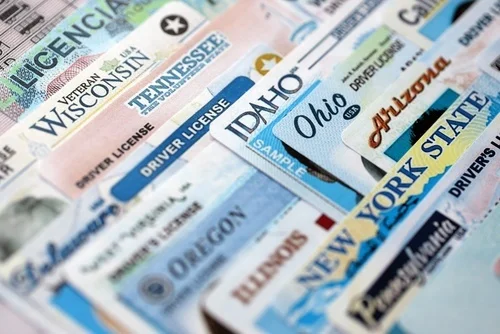Big amount of driving licenses from different USA states. Stack of driving license specimen cards